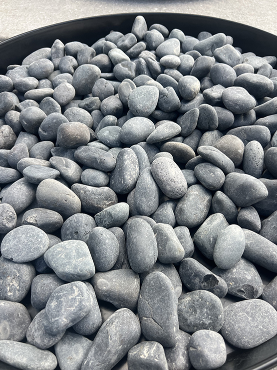 Blasted black pebbles close-up texture